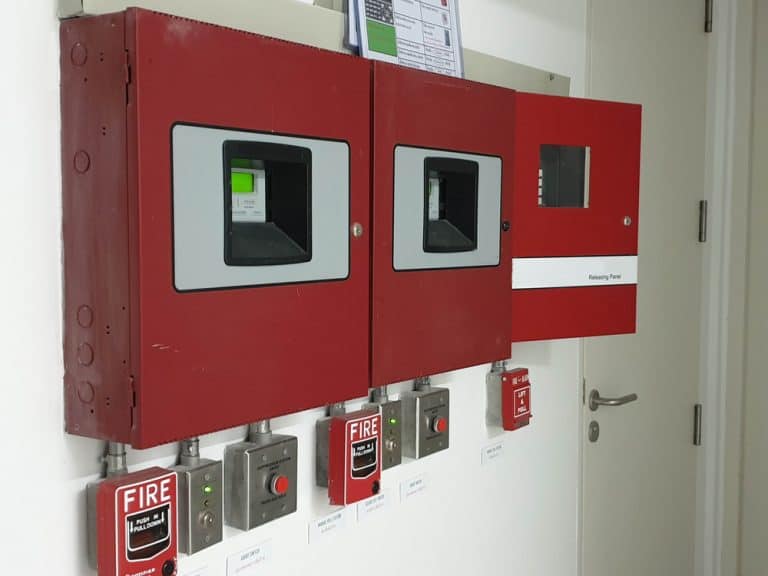 fire alarm control panel installed on interior wall.