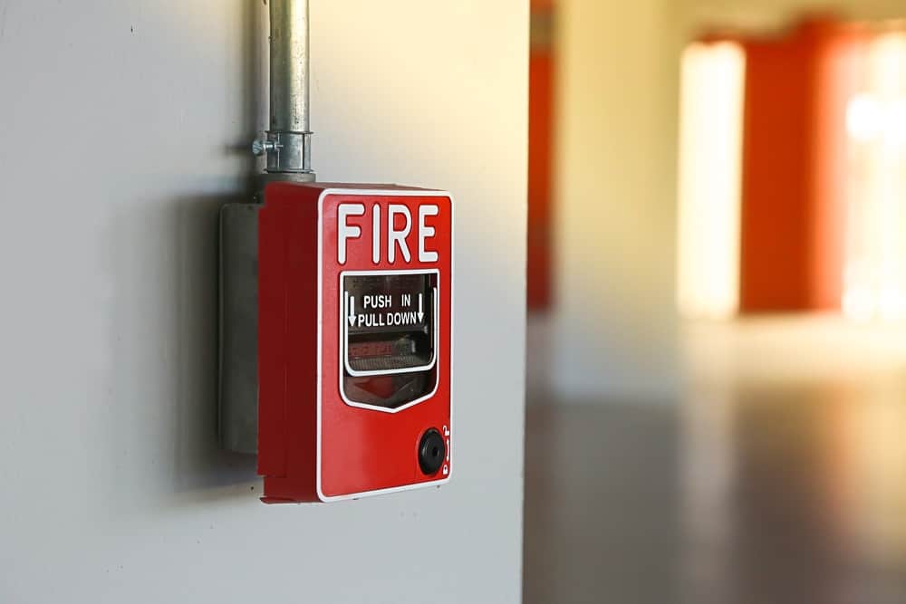 red fire alarm switch installed on wall.